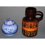 A West German pottery jug on a brown ground with incised decoration together with a 19th century