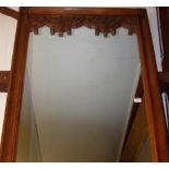 A Gothic influenced carved oak rectangular wall mirror,