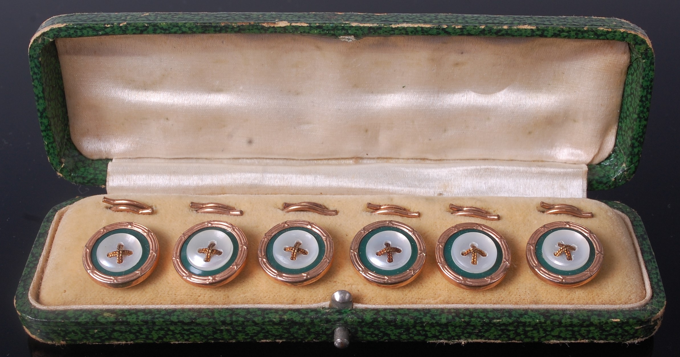 A cased set of six gilt metal dress buttons, each with mother of pearl and enamel fronts,