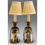 A pair of mid-20th century gilt brass table lamps, each with cast leaf decoration glass prism drops,