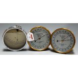 A pair of brass cased aneroid barometers, MkII, each having a silvered dial with millibar scale,