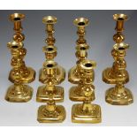 Five pairs of Victorian and later turned brass candlesticks,
