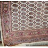 A modern Persian cream ground Bokhara carpet,