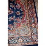 A Persian style woollen blue ground rug;