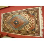 A small Persian woollen cream ground Tabriz rug,