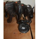 A large carved ebony figure of an elephant, a rhinoceros figure, and a carved elephant ashtray (3)