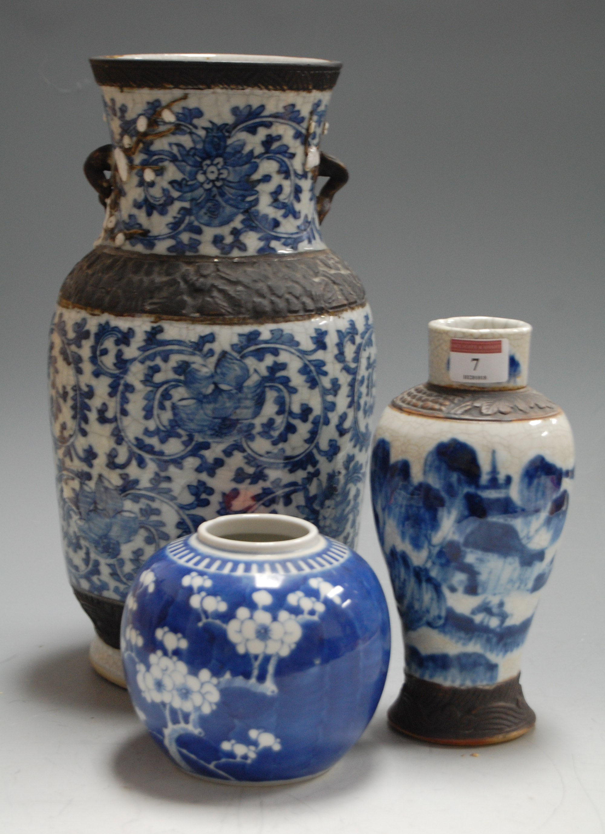 An early 20th century Japanese crackle glaze blue and white vase, of baluster form, having bronzed