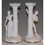 A pair of Franklin Mint fine porcelain Romeo & Juliet figural candlesticks, h.25cm