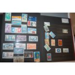 A box of miscellaneous loose stamps; together with an album of late 20th century world stamps