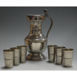 A 1970s Continental pewter flagon, the hinged cover with acorn thumbpiece; together with a