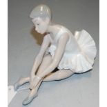 A Nao Spanish porcelain figure of a seated ballerina