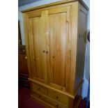 A contemporary pine double door wardrobe with lower drawers, width 110cm