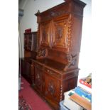 A late 19th century French heavily carved oak buffet aux corps, width 140cm