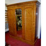 A Victorian figured walnut round cornered triple wardrobe, width 190cm