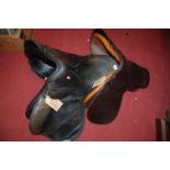 A black leather general purpose 18" saddle, a 14" pony saddle, and an Ideal 18.5" black leather
