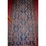 A Persian blue ground woollen hall runner, 297x88cm