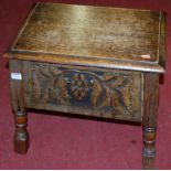 A relief carved oak sewing box, width 50cm