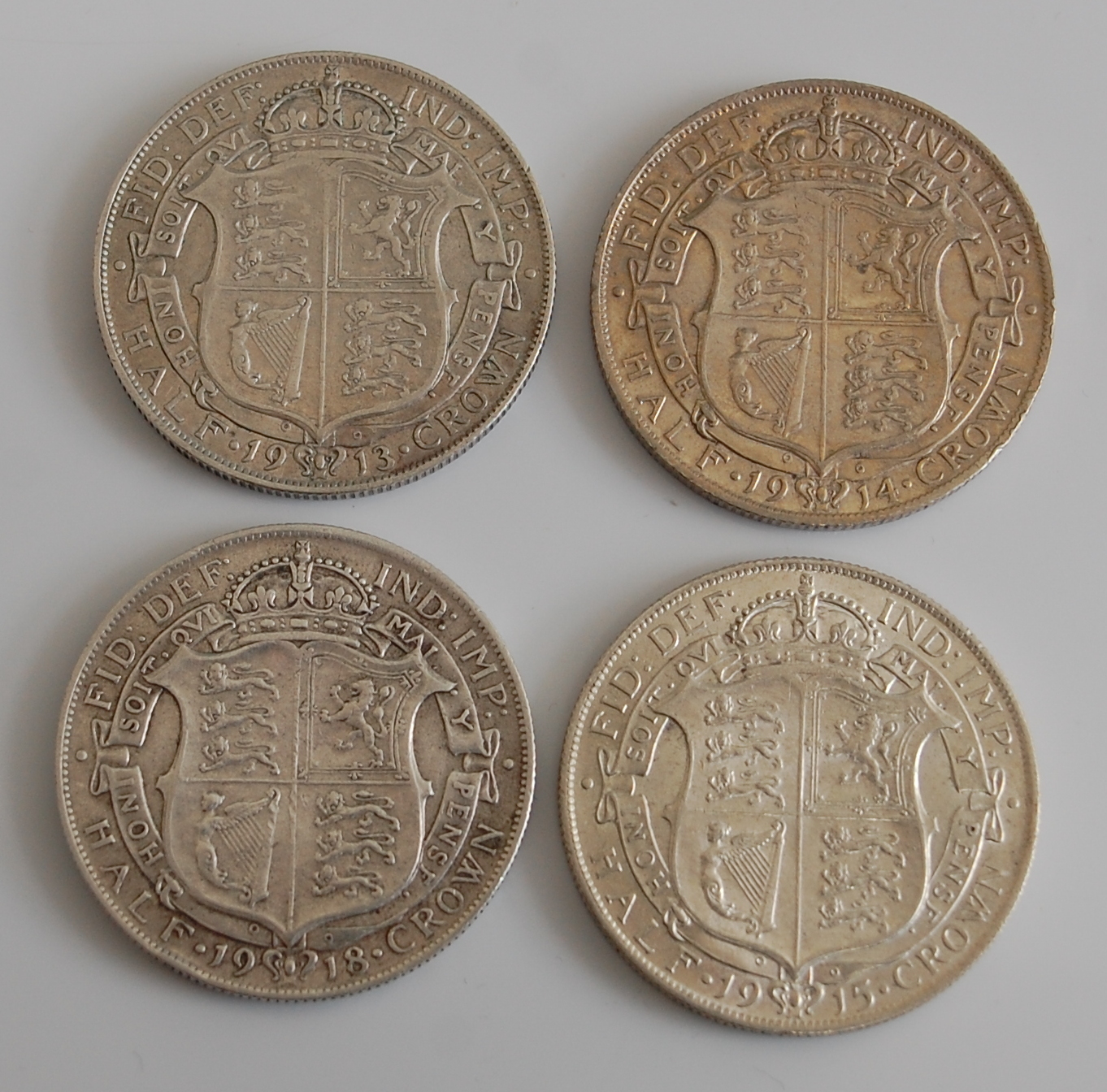 Great Britain, four George V half crowns, dated 1913, 1914,