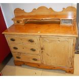 A Victorian stained pine side cupboard, having a raised superstructure, single door and three long