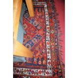 A Persian woollen blue ground carpet, having multiple trailing tramline borders, 290 x 200cm (worn