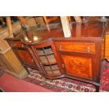 A circa 1900 mahogany and rosewood crossbanded part bowfront sideboard, having turned brass raised