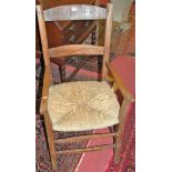Two rustic elm rushseat country elbow chairs; together with a wool-winder (3)