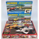 A Scalextric Grand Prix boxed slot car racing set together with two Scalextric track extension packs