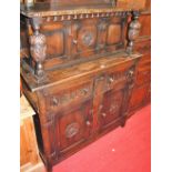 A carved and moulded oak court cupboard, of narrow proportions, w.107cm