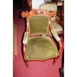 A pair of mid Victorian mahogany and flame mahogany barback open armchairs, each with green