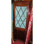 A 19th century mahogany freestanding astragal glazed corner cupboard