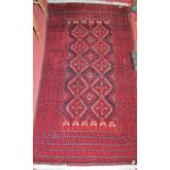 A Persian woollen Bokhara rug, having multiple borders and flatweave kelim ends, 165 x 85cm