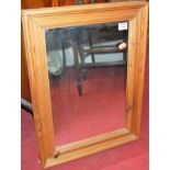 An Edwardian mahogany wall mirror; and two modern pine wall mirrors (3)