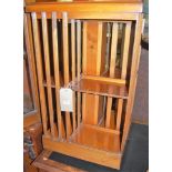 A reproduction yew wood and satinwood inlaid revolving eight division bookcase