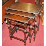 A 1930s oak nest of three occasional tables, the largest w.48cm