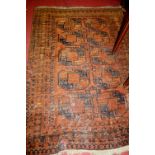 A Persian woollen Bokhara rug, having a brown field, 182 x 130cm (with major losses)