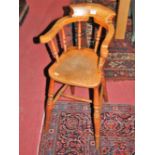 A circa 1900 elm childs' horseshoe stickback high chair