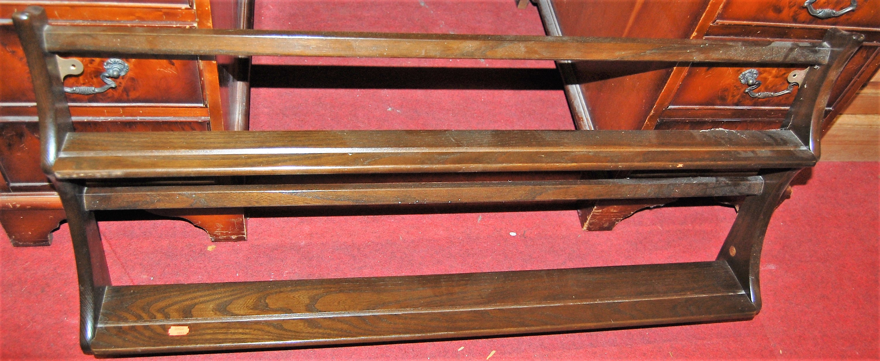 A contemporary Ercol dark elm two-tier plate rack, w.97cm