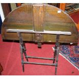 An early 20th century walnut folding campaign table, with label for Thornton & Herne, Pont Street,