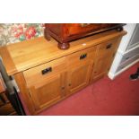 A contemporary light oak three door sideboard having three frieze drawers, width 148cm