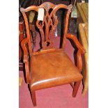 A pair of contemporary mahogany Chippendale style elbow chairs, each having tan leather studded