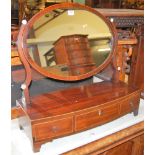 An Edwardian mahogany and satinwood strung oval swing dressing table mirror raised on three drawer