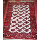 A Persian woollen Bokhara rug, having a cream ground, 150 x 110cm