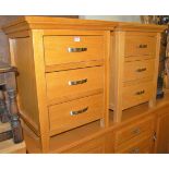 A pair of contemporary light oak three drawer bedside chests, w.54cm