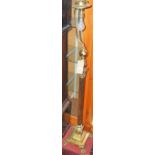A gilt brass Corinthian column standard lamp, raised on stepped base to paw feet