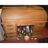 A contemporary oak rolltop twin pedestal writing desk, having leather inset upper surface, w.138cm