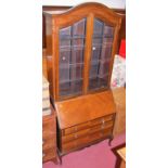 An early 20th century mahogany bureau bookcase having twin bevelled glazed panelled upper doors,