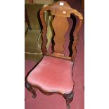 A set of four early Georgian style mahogany splatback dining chairs each having pink upholstered