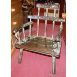 A painted hardwood stickback elbow chair, raised on chamfered supports, w.60cm
