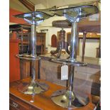 A pair of contemporary chrome and moulded polypropylene swivel breakfast bar stools