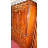 A 19th century mahogany, flame mahogany and rosewood crossbanded linenpress, the upper doors